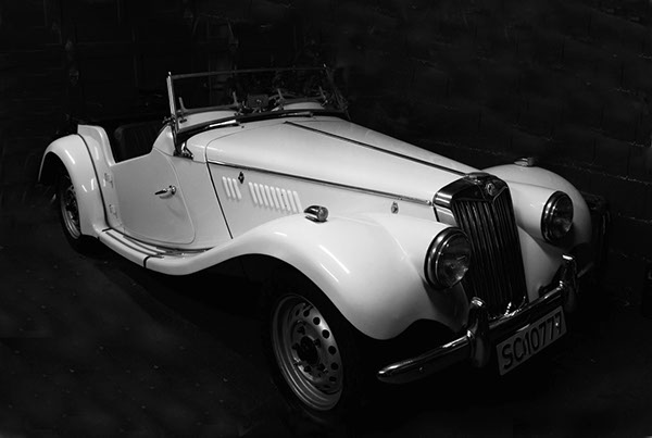MG TF sports car black and white photo.